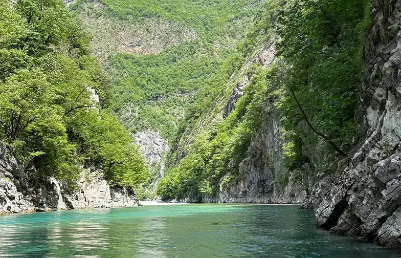 Clear turquoise water of the Shala River between limestone walls